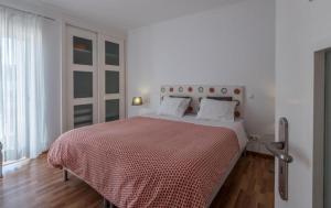 1 dormitorio blanco con 1 cama grande con manta roja en Beach Park Apartments, en Luz