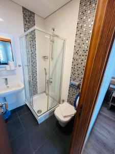 a bathroom with a shower and a toilet and a sink at Aycan Sultan Apart Hotel in Istanbul