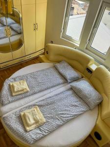 a bed with two pillows on it in a room at Apartment Alpi in Peje +36 photos