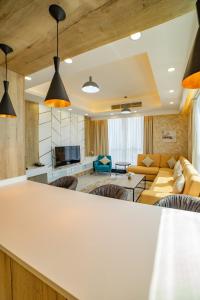 a living room with a couch and a table at Platinum Coast Hotel Apartments in Fujairah