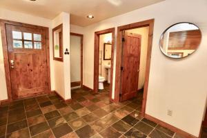 a hallway with a mirror and a bathroom at Bearadise by Casago McCall - Donerightmanagement in McCall +134 photos