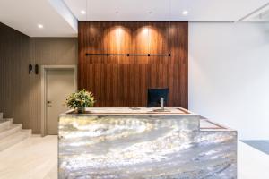 a lobby with a reception desk and a wooden wall at Apartamentos Core Suites Valencia in Valencia