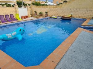 a swimming pool with a blue bear in the water at RR Villa in Monforte del Cid