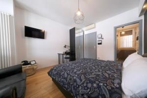 un dormitorio con una cama y un sofá en La boutique di via dell Indipendenza, en Bolonia