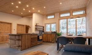 a large kitchen with a table and some windows at Silbersberg Cottage in Gloggnitz