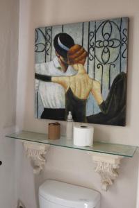 a painting on the wall above a toilet in a bathroom at DeKotzenhof in Wakkerstroom +187 photos
