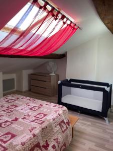 a bedroom with a bed with a red canopy at Maison à louer Les Roses in Arconville