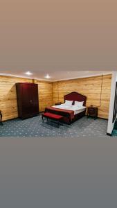 a bedroom with a bed and a bench in it at Eco Hotel Tan Tengri in Kostanay +28 photos