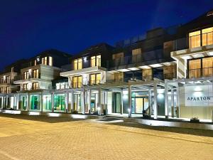 a lit up building at night at Aparton in Ustka