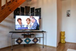 a flat screen tv sitting on a table in a room at Gaststaette & Pension Schinkenkrug in Hinrichshagen
