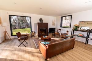 a living room with a couch and a fireplace at La Canopée de Mareil in Mareil-Marly