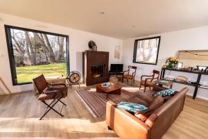 a living room with a couch and a fireplace at La Canopée de Mareil in Mareil-Marly