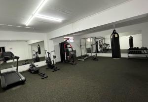 a gym with a bunch of equipment in a room at Eco Hotel Tan Tengri in Kostanay