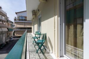 a balcony with two chairs and a table on it at Nice 2bedroom apartment in Pagkrati in Athens