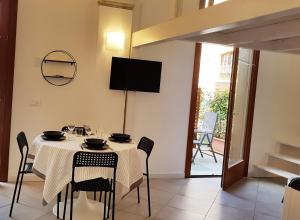 a dining room with a table with chairs and a television at Ex Convento Santa Caterina in Angera