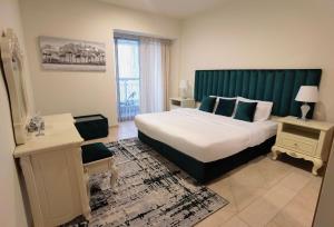a bedroom with a large bed with a green headboard at Serenity 3BR Palm view in Marina in Dubai