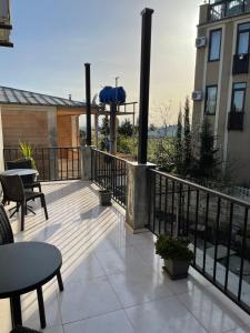 a balcony with tables and chairs on a building at Kvara's House in Kutaisi