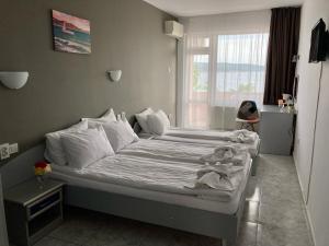 A bed or beds in a room at Plovdiv Hotel