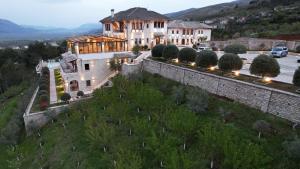 an aerial view of a house with a stone wall at KERCULLA Resort in Gjirokastër