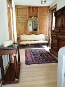 a living room with a couch and a rug at Au fil de l'eau in Cerdon