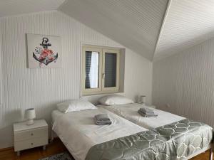 a bedroom with two beds and a window at B&B Sea Joy Rovinj in Rovinj