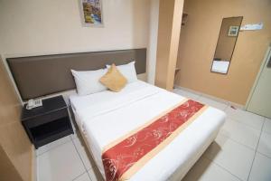 Postel nebo postele na pokoji v ubytování SohoTown Hotel