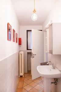 a bathroom with a white sink and a toilet at Sweet Home Pitti Verdelli in Crema