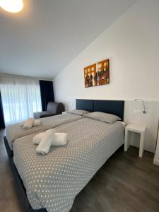 Voodi või voodid majutusasutuse Hotel Aurora & Appartamenti toas