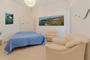 a bedroom with a bed and a couch and chairs at Da zio Antonio in Vieste