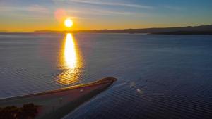 an aerial view of the ocean at sunset at Zlatni Rat Beach Resort in Bol