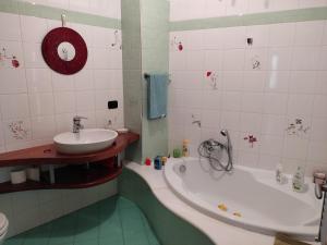 a bathroom with a tub and a sink at 100 Passi Castelbuono Experience in Castelbuono +28 photos