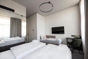 a hotel room with two beds and a flat screen tv at The Gold Bank in Prague