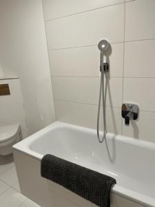a white bathroom with a bath tub and a toilet at Christinenhof Top 5 mit großem Balkon in Lofer