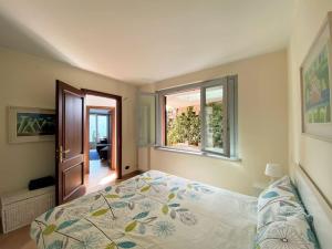 a bedroom with a bed and a window at San Sisinio Apartment Argegno in Argegno