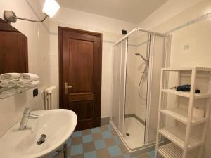 a bathroom with a shower and a sink and a shower at San Sisinio Apartment Argegno in Argegno +17 photos