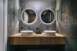 two sinks in a bathroom with two mirrors at Rezydencja Bieszczady - Solina in Solina