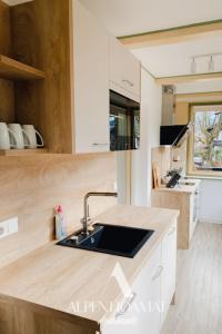a kitchen with a sink and a counter top at Alpenhoamat Apartments in Garmisch-Partenkirchen
