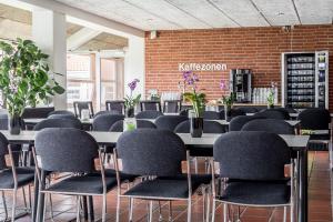 a row of tables and chairs in a room at Sportshotel Vejen in Vejen