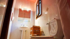 a small bathroom with a sink and a toilet at VILLA DREAM in Skiathos Town +13 photos