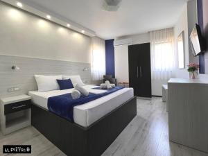 a bedroom with a large bed in a room at La Pietra Family Hotel in Međugorje