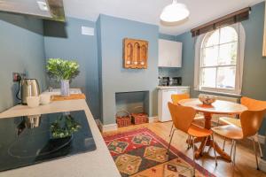 a kitchen and dining room with a table and chairs at Cliffe Cottage in Lewes