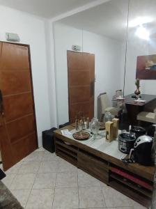 a room with a counter with a table with food on it at Serra Negra - Melhor localização da cidade in Serra Negra