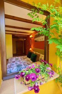 a bedroom with a bed with purple flowers on it at Hotel Doñana Blues in Matalascañas