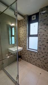 a bathroom with a sink and a window at Waltair Abode in Visakhapatnam