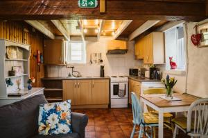 a kitchen with a table and a dining room at Innish Beg Cottages in Blaney