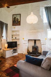 a living room with a couch and a fireplace at Innish Beg Cottages in Blaney