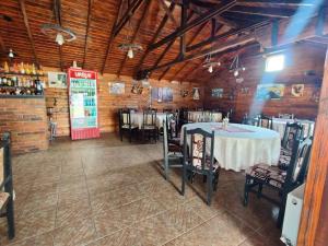 a dining room with a table and chairs in it at La Cabană Girov in Girov