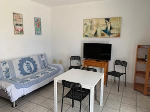 a living room with a couch and a table and a tv at Mar Azul Arinaga in Arinaga