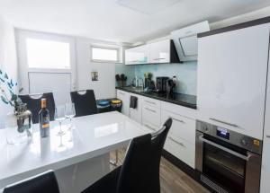 a kitchen with a white counter top and black appliances at Panoramahaus Hopfner Nähe Zugspitze und Eibsee in Garmisch-Partenkirchen