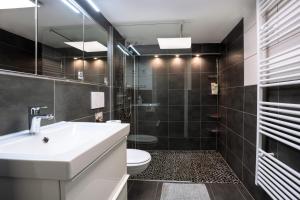 a bathroom with a sink and a toilet at Panoramahaus Hopfner Nähe Zugspitze und Eibsee in Garmisch-Partenkirchen +12 photos